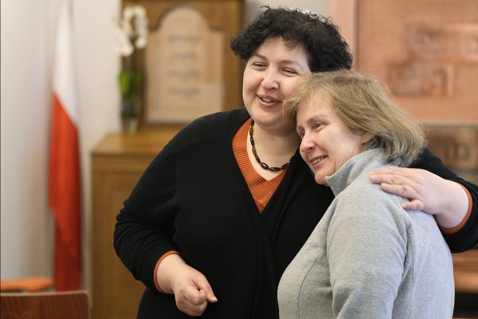 Rabbi Julia Gris, left, who led a Progressive Jewish congregation in Odesa, Ukraine, hugs a member of her congregation. CZAREK SOKOLOWSKI/ASSOCIATED PRESS